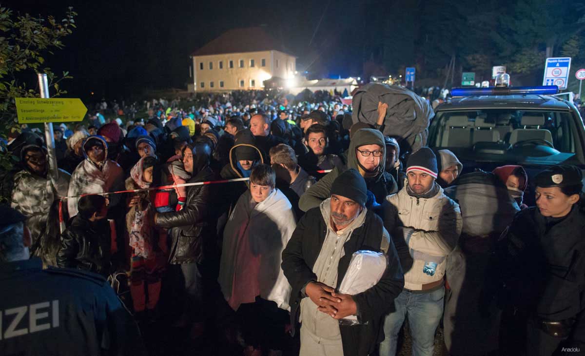 Refugees wait at the border between Austria and Germany, on October 28, 2015 near Kollerschlag, Austria