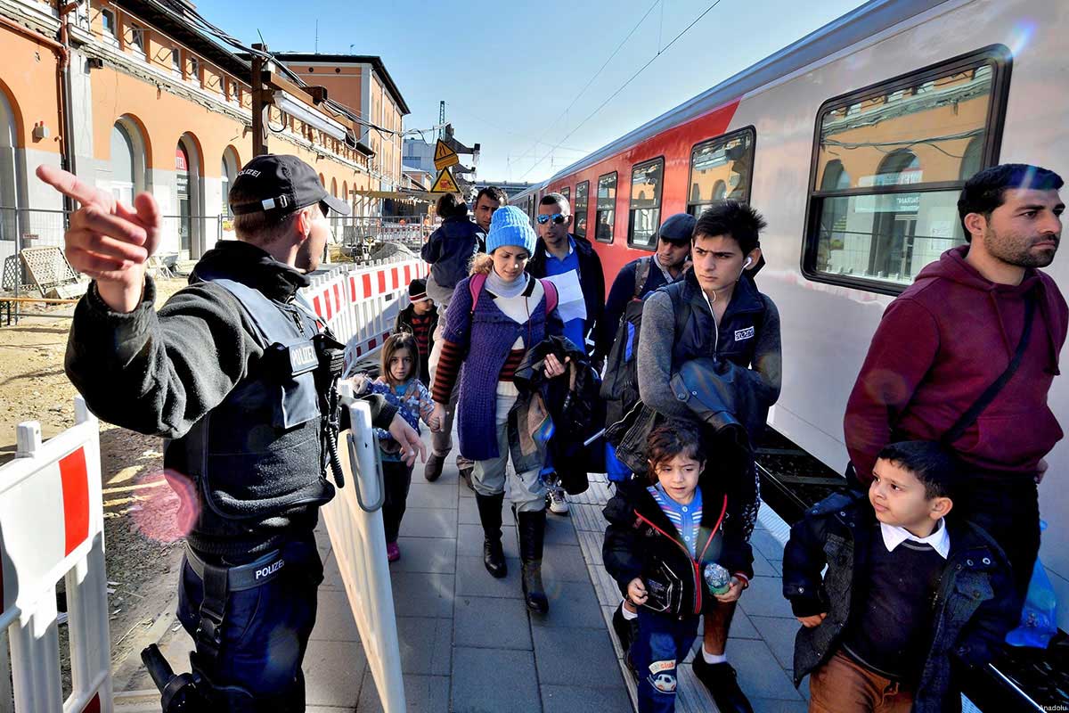 Refugees are seen arriving on train in the South East German town of Passau. Among the EU states, Germany faces the biggest refugee influx, as authorities expect a record 800,000 asylum applications this year, four times the last year's total.