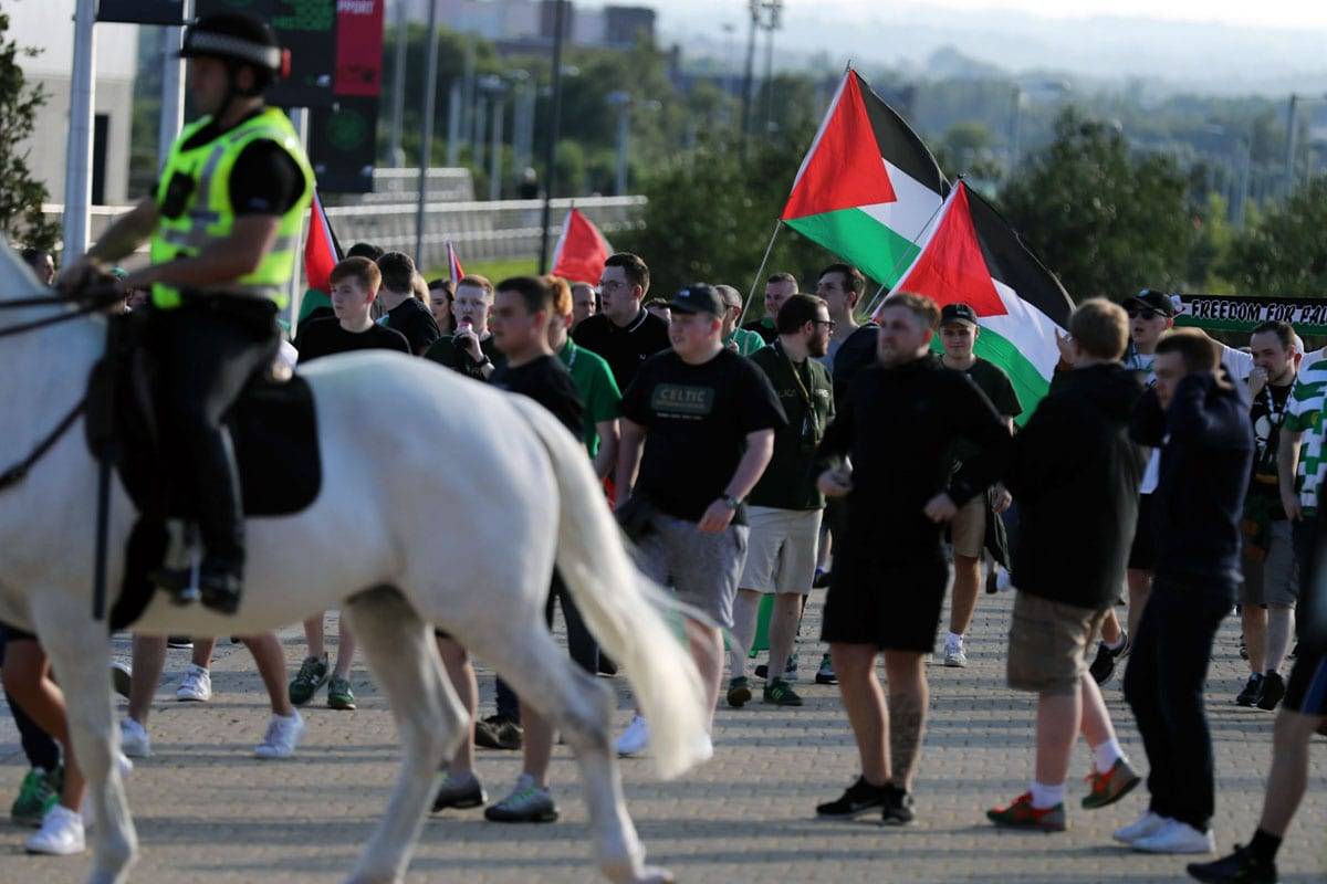 Scottish football fans fly flag of Palestine in match against