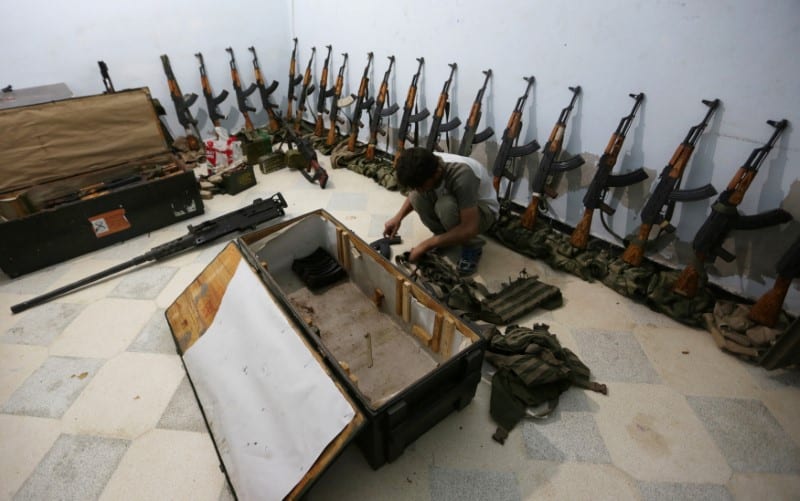 A rebel fighter arranges weapons in Aleppo, Syria on September 26 2016 [REUTERS/Khalil Ashawi]
