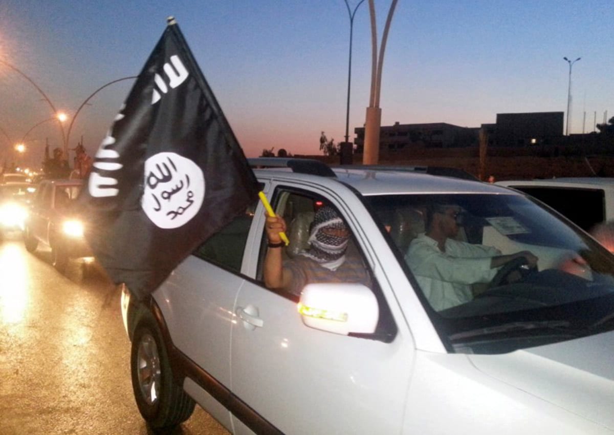 Daesh militants wave their flag [REUTERS/Stringer/File Photo]