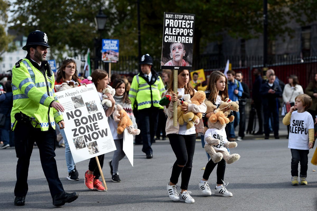 In a protest organised by War Child, Avaaz and Amnesty International in London, protestors gather with teddy bears and placards calling on the British government to take action to protect the children of the Syrian city of Aleppo outside on October 22, 2016 [Kate Green/Anadolu]