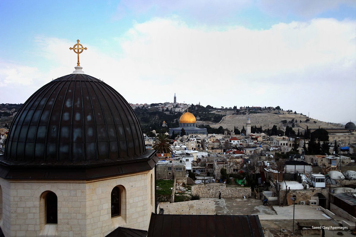 A general view from the tower of the Church of Redeemer shows the Dome of the Rock mosque and the cross of the Church of the Holy Sepulchre in the old city of Jerusalem, on February 17, 2014 [Saeed Qaq/Apaimages]