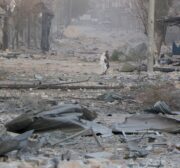 Residents escape from the scene of air strikes carried out by Assad regime forces in Aleppo, Syria on December 9 2016 [Anadolu]