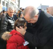 Turkish President Recep Tayyip Erdogan talks with the relatives of the casualties of Istanbul terror attack during a funeral ceremony at Istanbul Police Department headquarters in Istanbul, Turkey on December 11, 2016 [Kayhan Özer / Anadolu Agency]