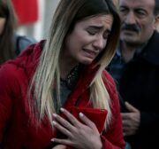 A woman cries as people leave carnations for the victims of Istanbul terror attacks near the Vodafone Arena in Istanbul's Besiktas, Turkey on December 11, 2016 [Onur Çoban / Anadolu Agency]