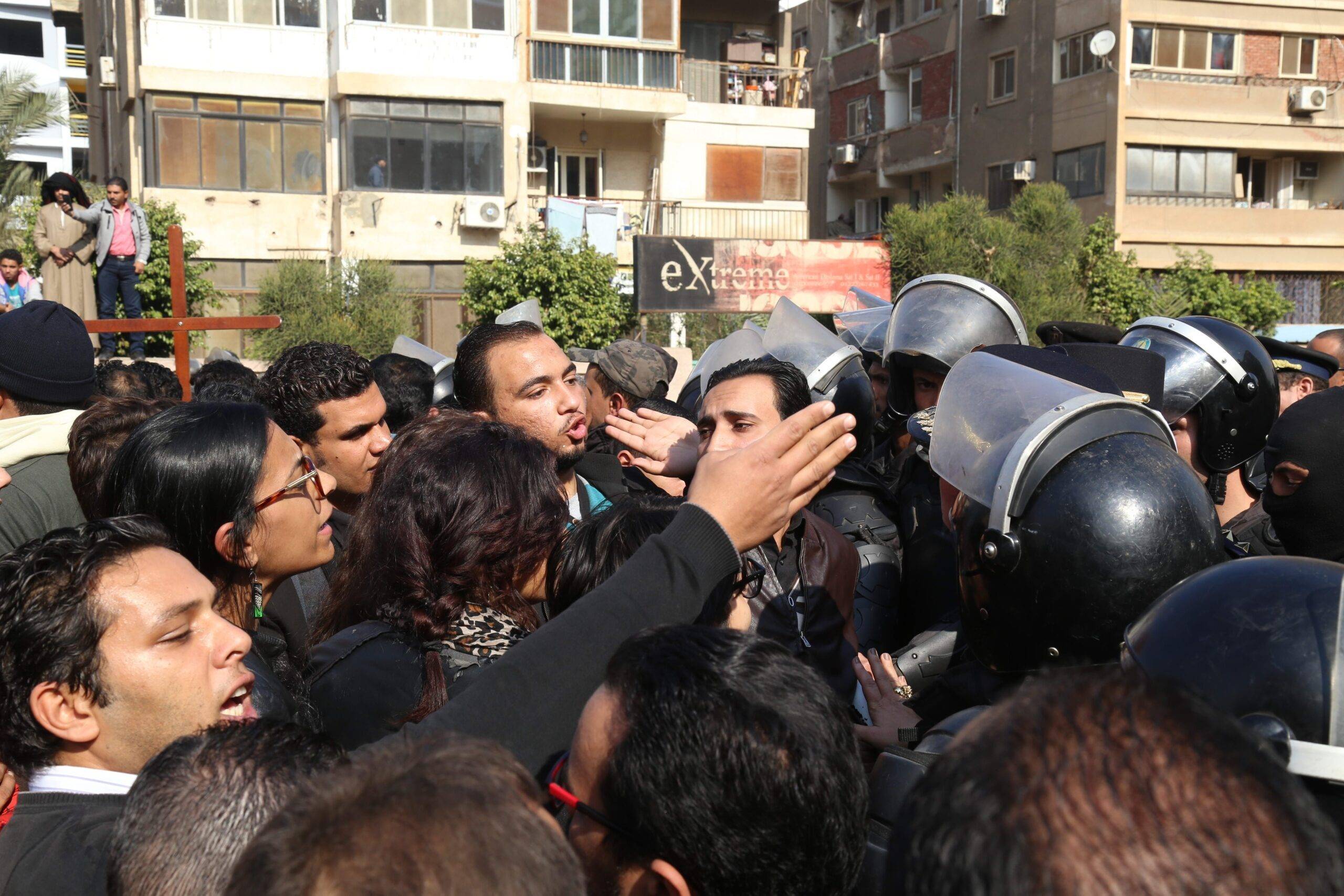 Security forces intervene people during the funeral ceremony for the victims of the explosion at Saint Peter and Saint Paul Coptic Orthodox Church in Abbasiya district, at Church of the Virgin Mary in Nasr City neighborhood of Cairo, Egypt on 12 December, 2016 [Ahmed Gamil/Anadolu Agency]