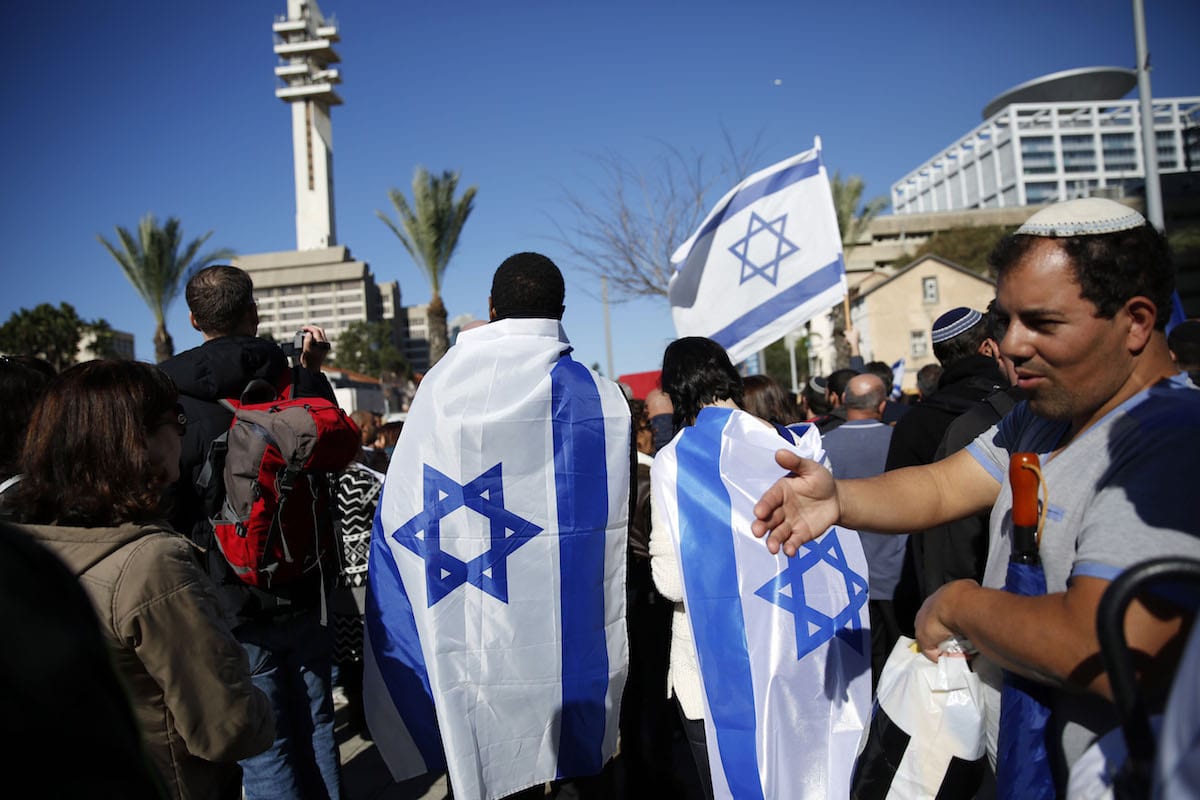 Supporters of Israeli soldier Elor Azaria, who is judged for shooting a wounded Palestinian in his head in West Bank's Hebron, gather outside of the court to show their support to him during the trial in Tel Aviv, Israel, on January 04, 2017 [Daniel Bar On / Anadolu Agency]