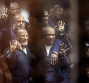Senior political figures of the Muslim Brotherhood Saad El-Katatni (2nd L) gesture during a trial session over the Wadi el-Natrun prison case at Cairo Police Academy in Egypt on 26 February, 2017 [Moustafa El Shemy/Anadolu Agency]