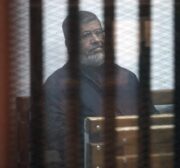 Egypt’s ousted President Mohamed Morsi attends a trial session in Cairo, Egypt on February 26, 2017 [Moustafa El Shemy/Anadolu Agency]