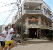 Participants run past the the Walled-Off Hotel, Banksy's newly opened hotel in Bethlehem, West Bank [Wisam Hashlamoun/Apaimages]