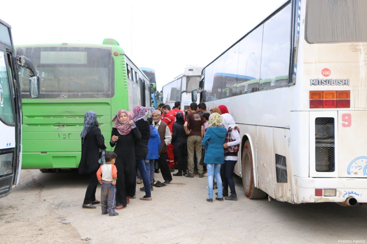 Syrian regime supporters arrive at Syria's Rashidin area by bus under a deal between regime and opposition forces on April 14, 2017. ( Bilal Baioush - Anadolu Agency )
