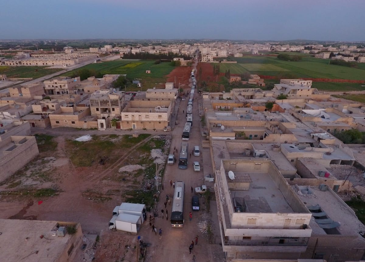 Buses carry Syrian civilians and opponent forces members, evacuated from Al-Waer district of Homs, Syria on April 19, 2017 [Jawad Al Rifai - Anadolu Agency]