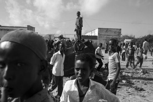 Somalian children stand on the remains of an exploded car [Ty Faruki]