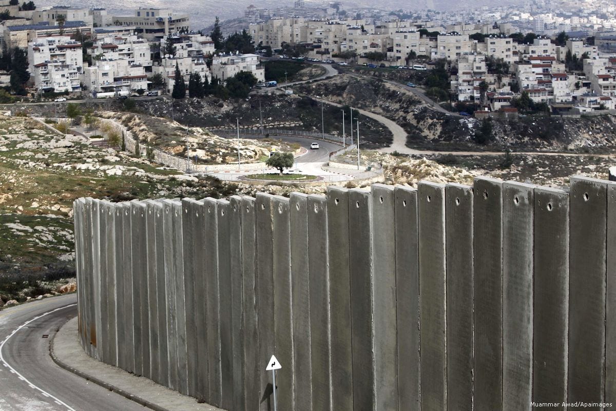 View of the Palestinian Shuafat refugee camp behind Israel's apartheid wall in east Jerusalem on 3 December 2014 [Muammar Awad/Apaimages]