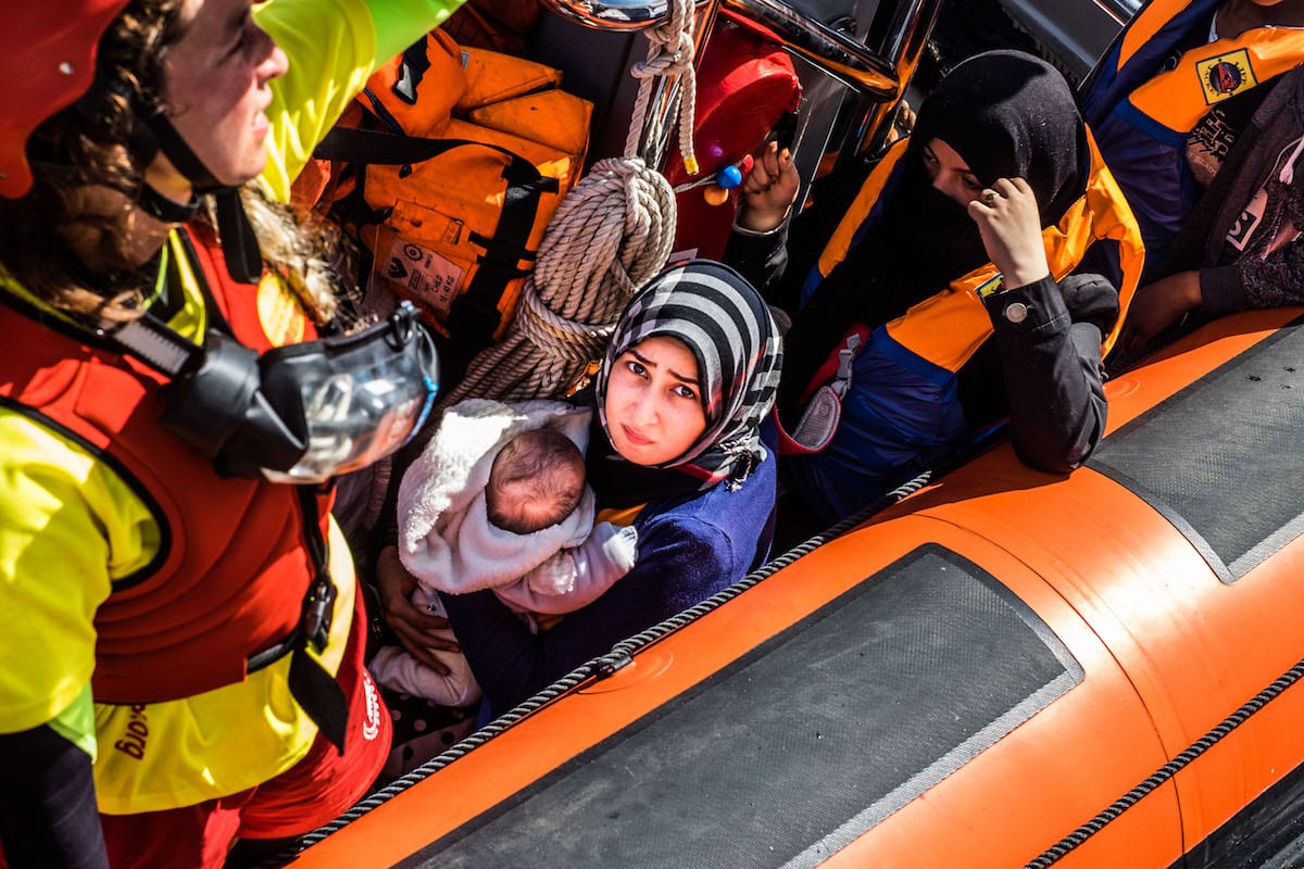 Refugees are seen after being rescued from the Mediterranean Sea on 15 June 2017 [Marcus Drinkwater/Anadolu Agency]