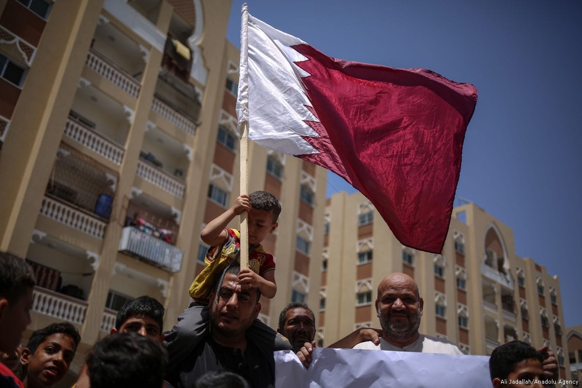 Palestinian people hold flags and banners during a demonstration in support of Qatar, in Gaza on 9 June 2017 [Ali Jadallah/Anadolu Agency]