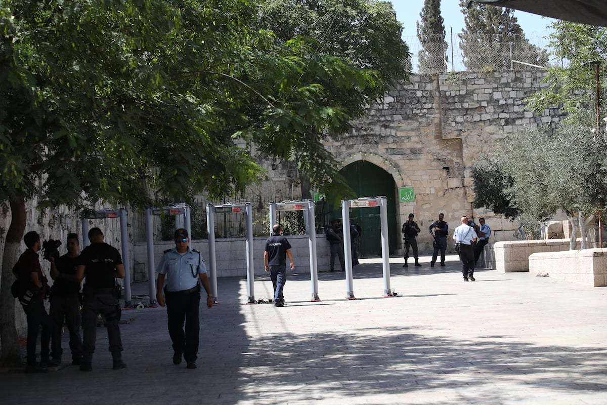 Israeli security forces set up metal detectors at the entrance of Al Aqsa Mosque after the Israeli authorities closed Jerusalem’s flashpoint Al-Aqsa mosque compound on Saturday following a shootout that left five people dead, in Jerusalem on July 16, 2017. [Mostafa Alkharouf - Anadolu Agency]