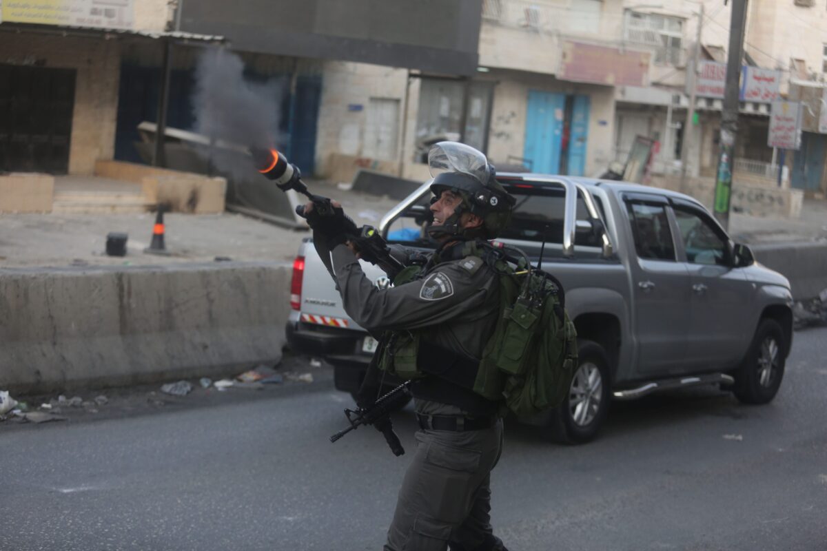 Israeli security forces intervene to Palestinian protesters using teargas bomb during clashes in Ramallah, West Bank, on 23 July, 2017 [Issam Rimawi/Anadolu Agency]