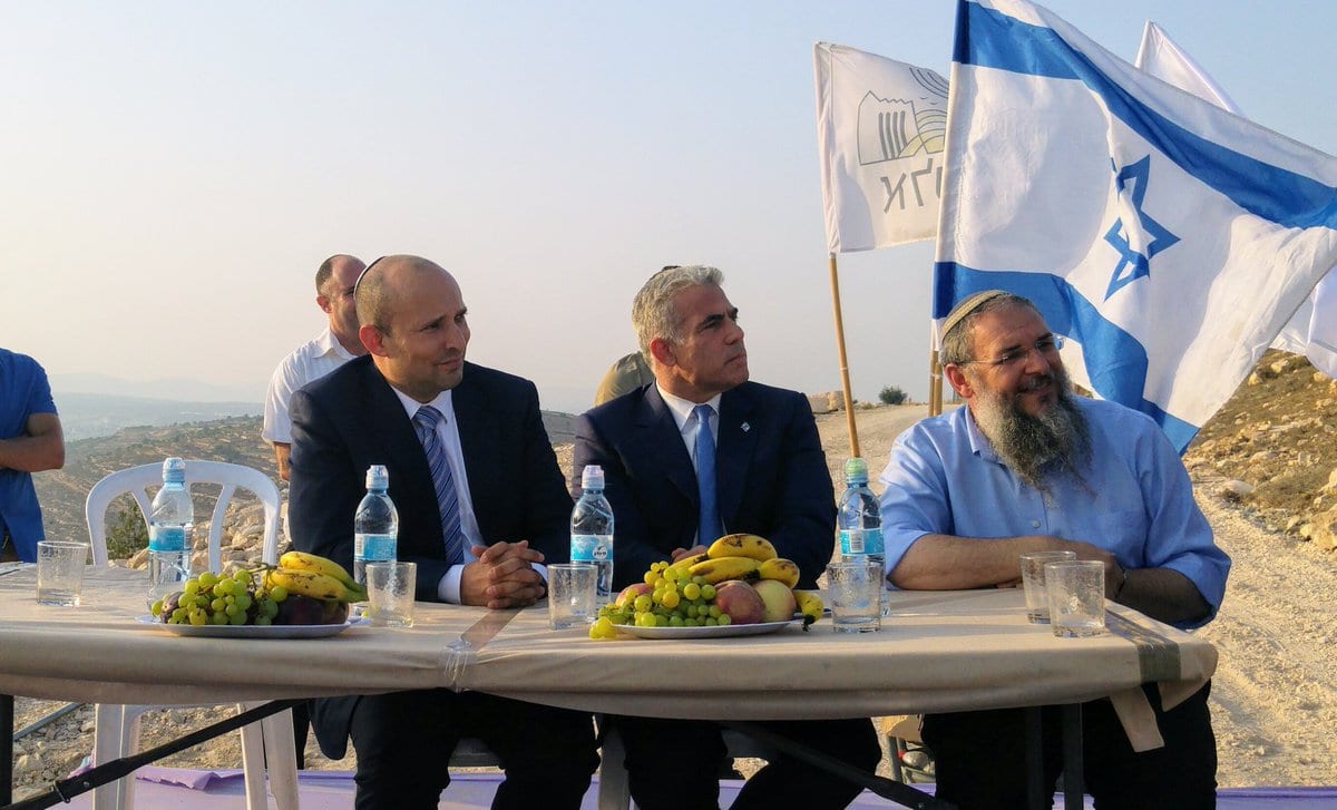Yair Lapid, the head of the Yesh Atid party, and Israeli Education Minister Naftali Bennett, head of the ultra-right-wing Jewish Home Party, joined settlers on 23 July 2017 at the inauguration of a monument that was rebuilt in the illegal settlement outpost of Netiv HaAvot after the Israeli Supreme Court ordered the outpost’s demolition and the evacuation of all settlers.[Yigal Dilmoni/Twitter]