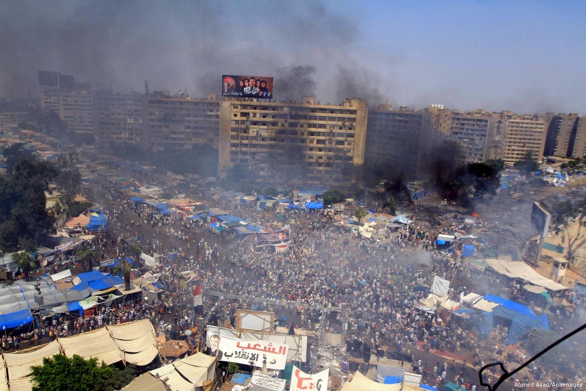 Smoke rises at Rabaa al-Adawya square following clashes between supporters of the ousted president Morsi and riot police in Cairo, Egypt on14 August 2013 [Ahmed Asad/Apaimages]