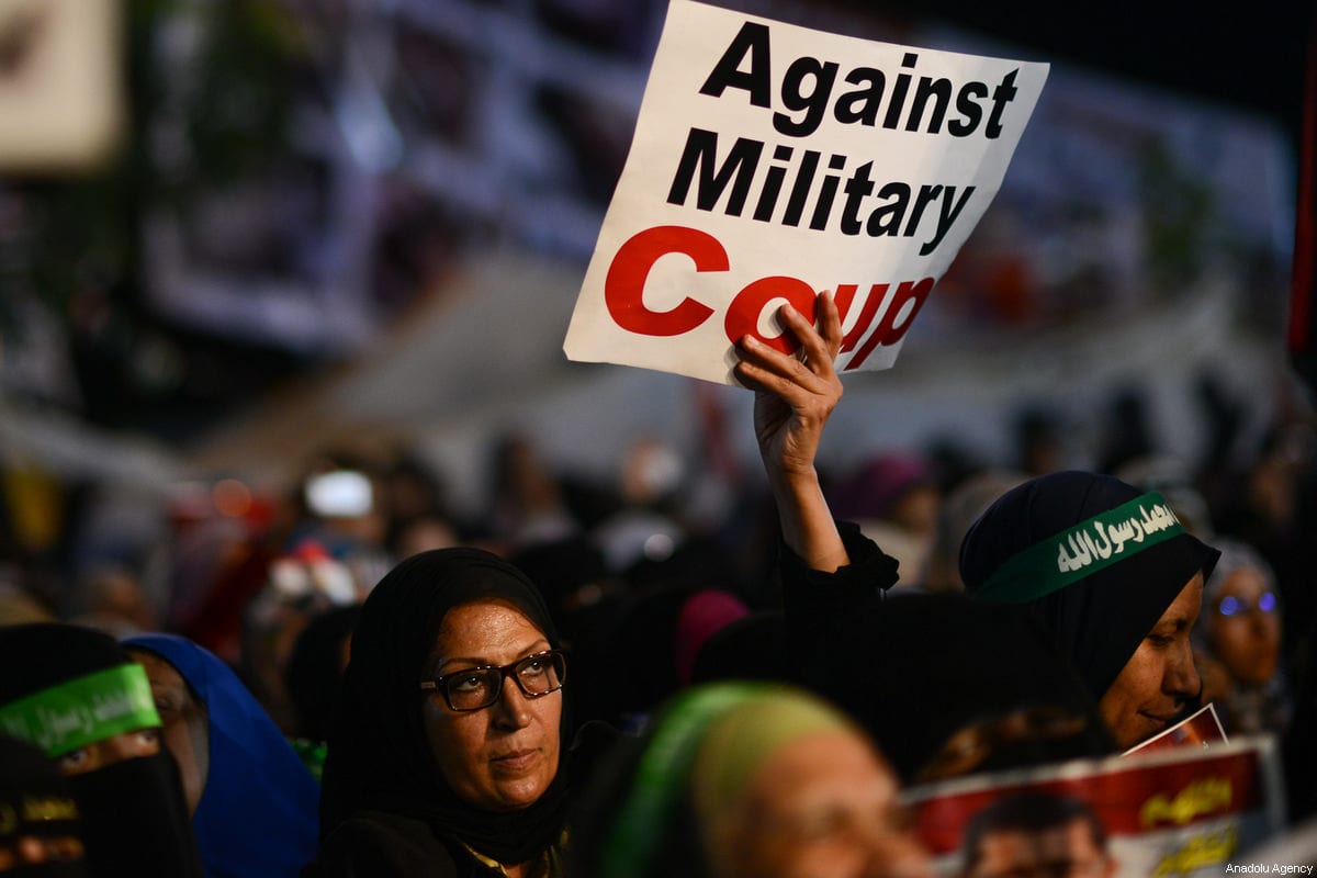 A file photo dated July 31, 2013 shows a female protester supporting Mohammed Morsi holds a banner reading 'Against Military Coup' in Rabia Adaweya Square in Cairo, Egypt [Mohammed Elshamy/Anadolu Agency]