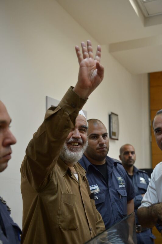 Leader of the Northern Branch of the Islamic Movement in Israel, Sheikh Raed Salah (2nd L) appears in court after he was taken under custody on the grounds that he allegedly provoked and supported an illegal association, in Rishon Lezion, Israel on 14 August , 2017 [Stringer/Anadolu Agency]