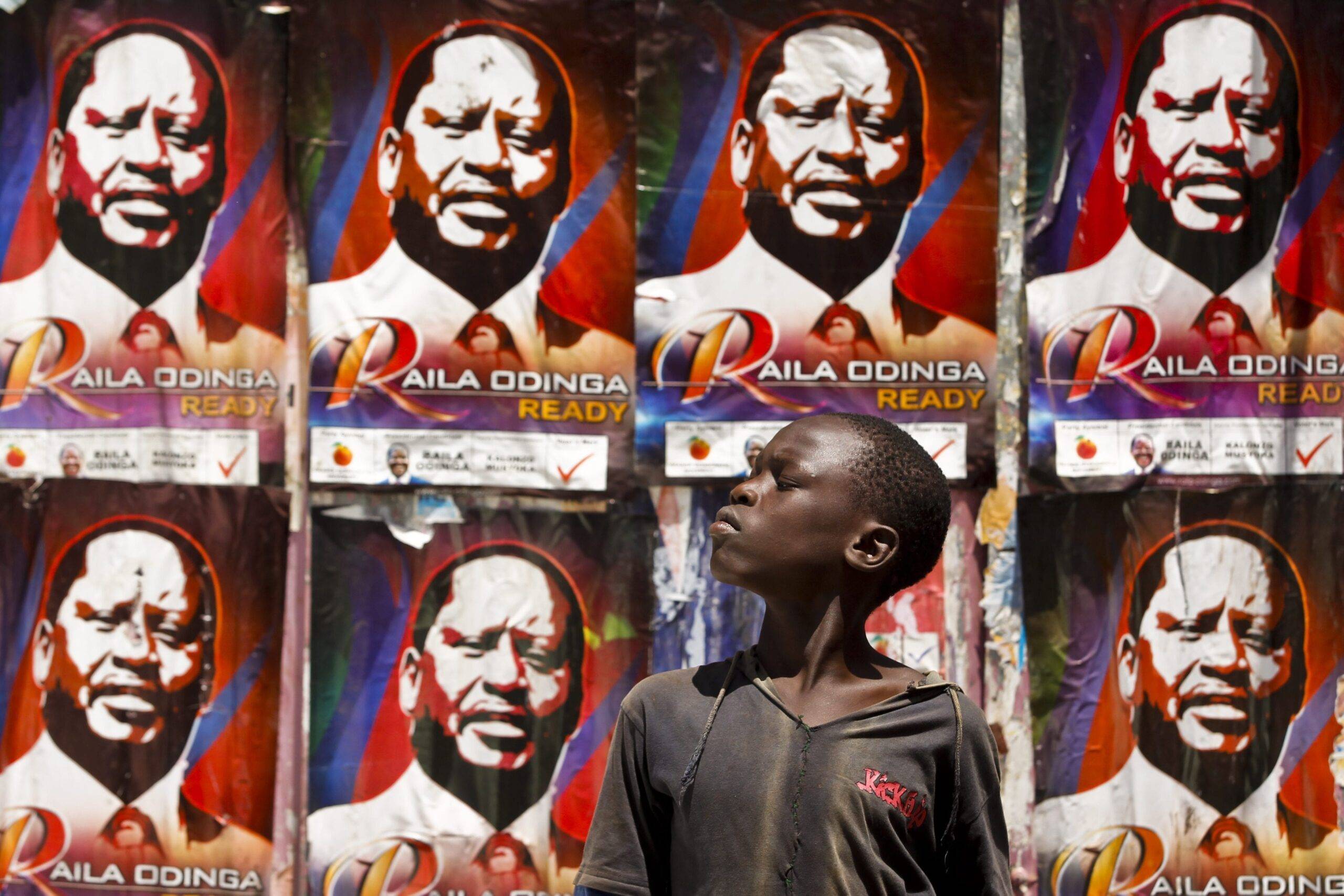 A young Kenyan boy looks on in front of the prime minister Raila Odinga's campaign posters on the wall near a polling station in the Kibera slum, Nairobi, Kenya, 04 March 2013 [EPA/Dai Kurokawa]