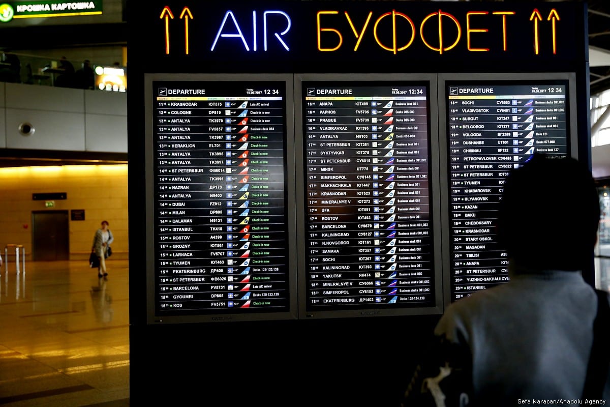 A passenger looks at scheduled flight timetables at the Vnukovo International Airport in Moscow, Russia, on 19 September, 2017 [Sefa Karacan/Anadolu Agency]