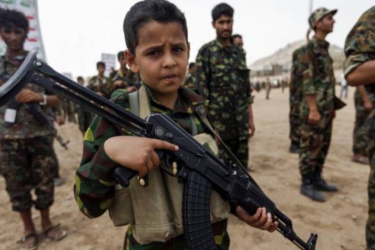 A Yemeni boy poses with a Kalashnikov assault rifle during a gathering of newly-recruited Houthi fighters in the capital Sanaa, to mobilise more fighters to battlefronts in the war against pro-government forces in several Yemeni cities, on July 16, 2017 [MOHAMMED HUWAIS/AFP/Getty Images]