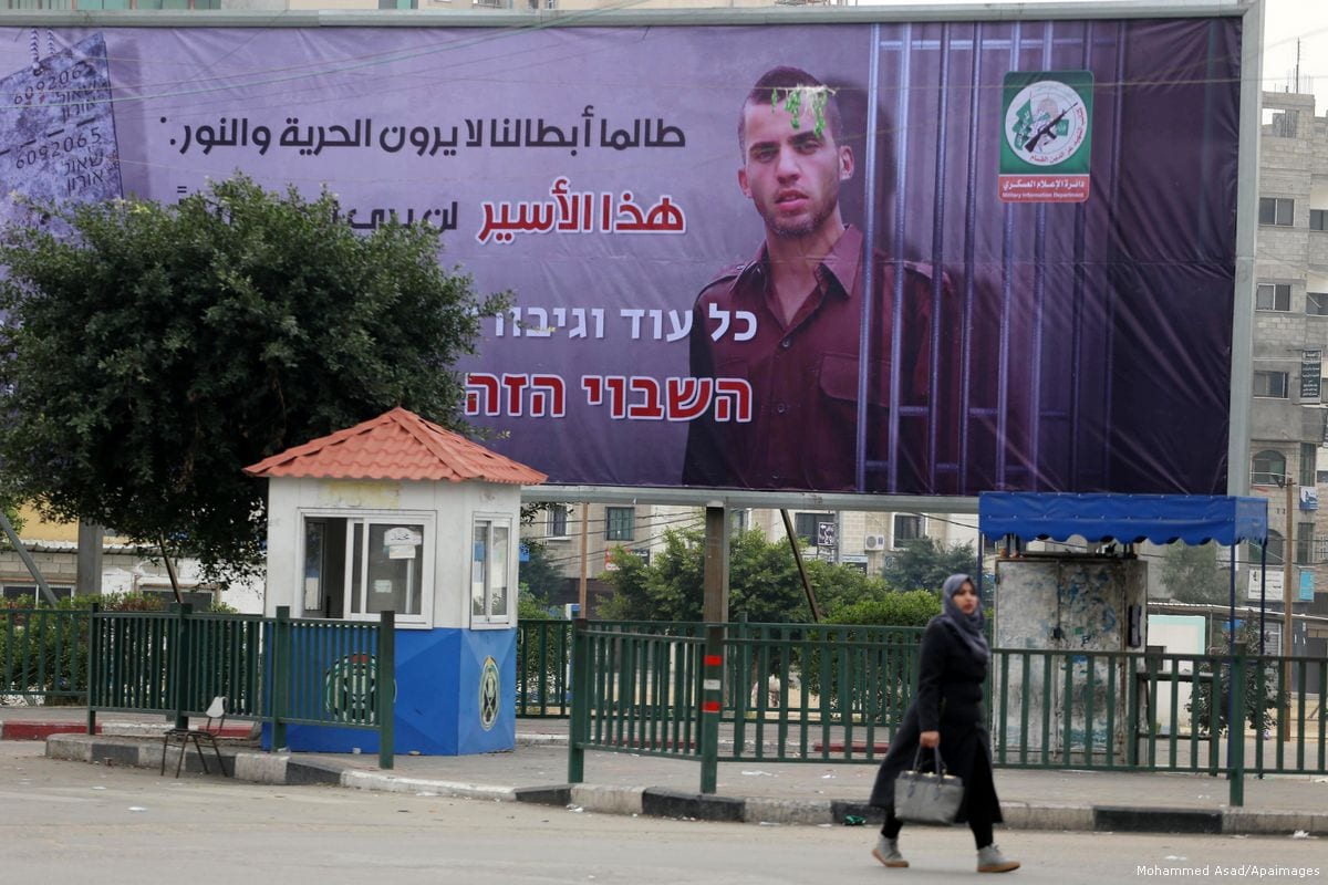 Placed at the Al-Saraya junction in Gaza, a billboard shows Shaul Arun, an Israeli solider, standing with jail bars around him [Mohammed Asad/Apaimages]