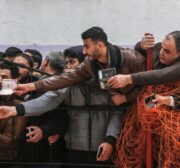 Gazans wait for a bus, which will transport them to Egypt, after Egyptian authorities opened the Rafah border gate on 8 February 2018 [Ali Jadallah/Anadolu Agency]