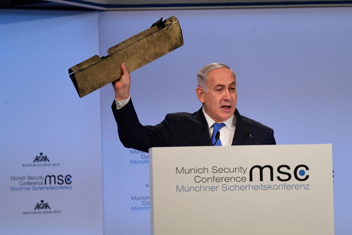 Israel's Prime Minister Benjamin Netanyahu holds up a piece of wreckage he claims is from an Iranian drone that was shot down by Israel on February 10, at the 54th Munich Security Conference (MSC) in Germany on 18 February, 2018 [Andreas Gerbert/Anadolu Agency]