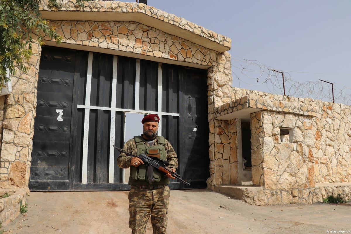 A member of Free Syrian Army (FSA) poses for a photo in front of a prison, which was used by PKK to withhold opponents, after it was captured by FSA following the liberation of Afrin by Turkish Armed Forces and FSA within the "Operation Olive Branch" launched in Syria's Afrin, on March 24, 2018 [Hişam El Homsi - Anadolu Agency]
