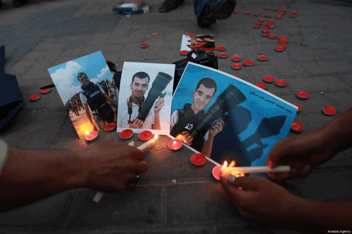 Palestinian journalists light candles to commemorate Palestinian journalist Yaser Murtaja, who was martyred by Israeli soldiers during "Great March of Return", during a protest in Nablus, West Bank on 7 April, 2018 [Nedal Eshtayah/Anadolu Agency]