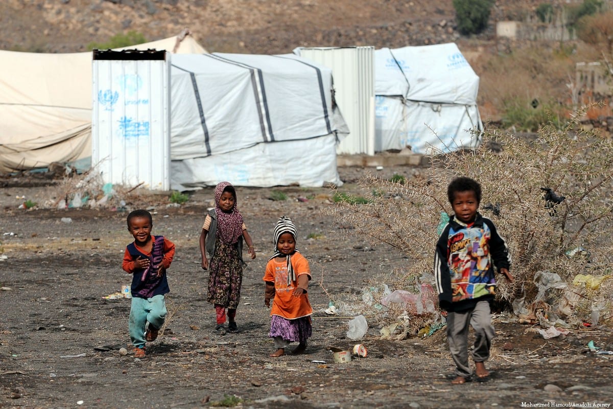 Children are seen in front of makeshift tents at Darwan refugee camp in Amran north of Sana’a, Yemen on 11 April 2018 [Mohammed Hamoud/Anadolu Agency]