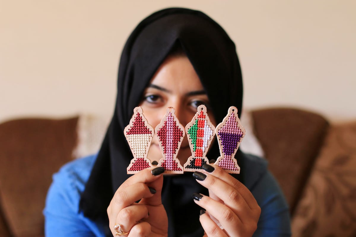 A Palestinian girl Nariman Abu Obaid, 21, uses strings to embroidery on wood as she manufactures traditional lanterns known in Arabic as "Fanous" on the holy month of Ramadan in Deir Al Balah in the center of Gaza Strip, on 17 May, 2018 [Mahmoud Khattab/A[aimages]