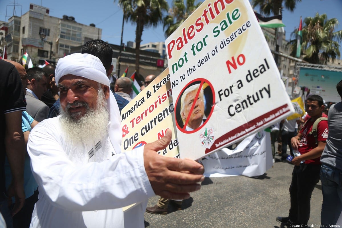 Palestinians stage a protest against the 'Deal of the Century', planned by US President Donald Trump to solve the conflict between Palestine and Israel, in Ramallah, West Bank on 2 July 2018 [Issam Rimawi/Anadolu Agency]