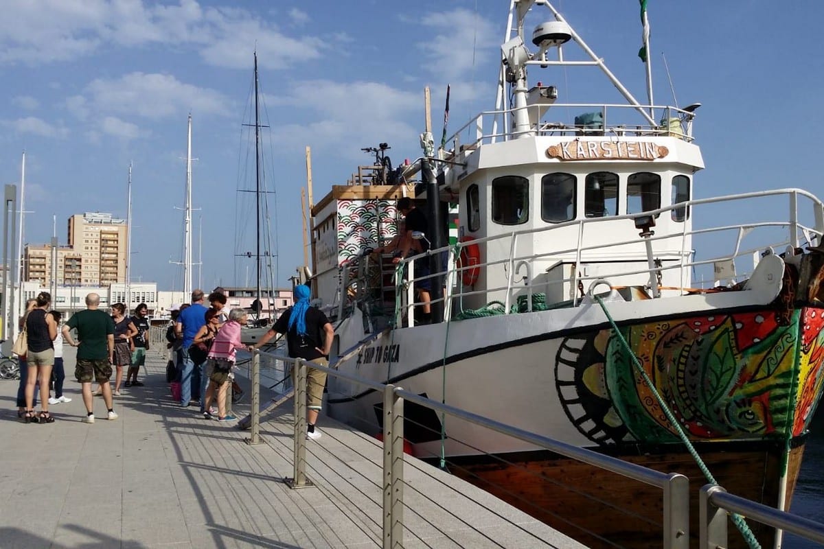 People greet the Freedom Flotilla in Italy, seen on July 3, 2018