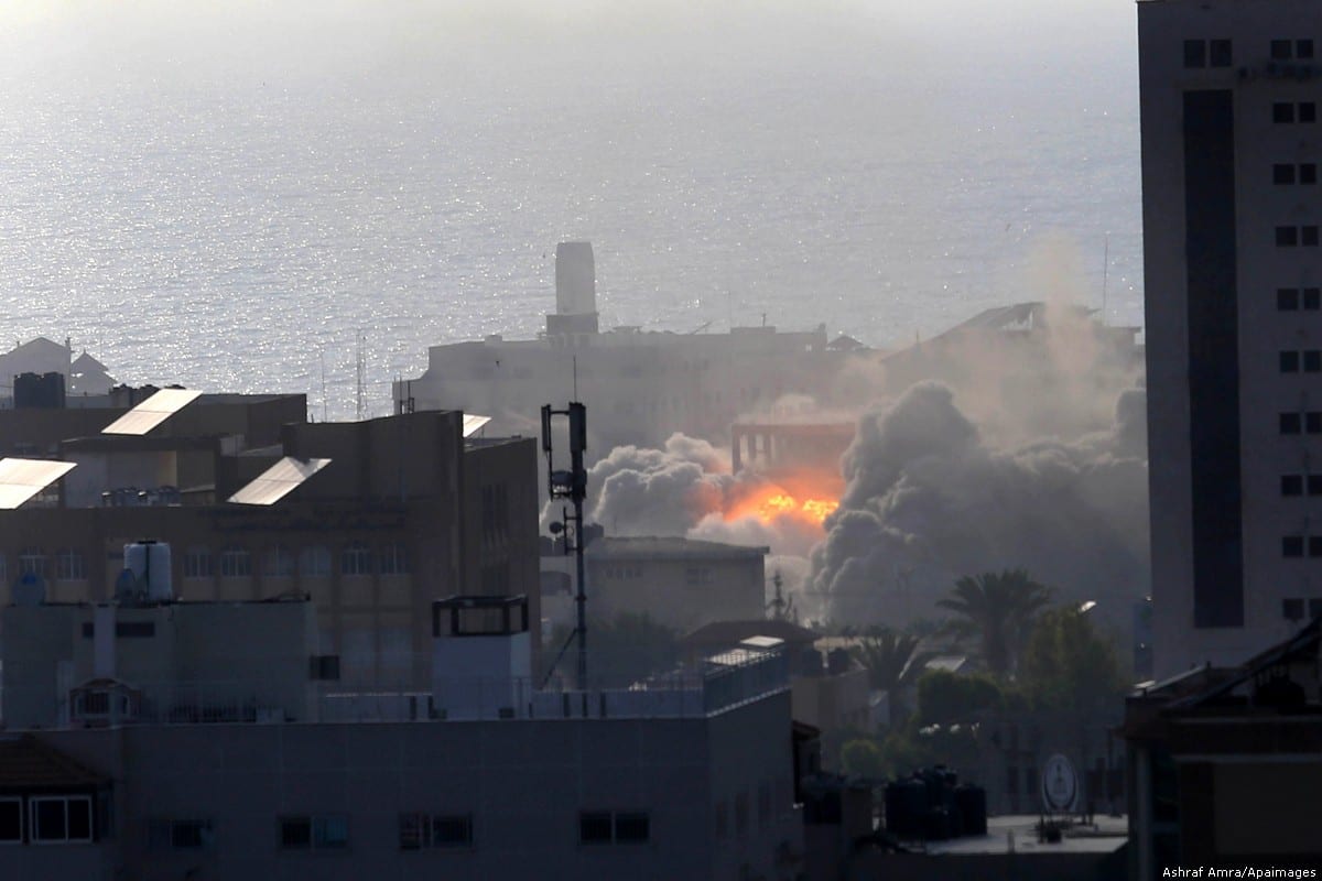 Smoke and fire rises above buildings during an Israeli air strike on Gaza City on 14 July 2018 [Ashraf Amra/Apaimages]