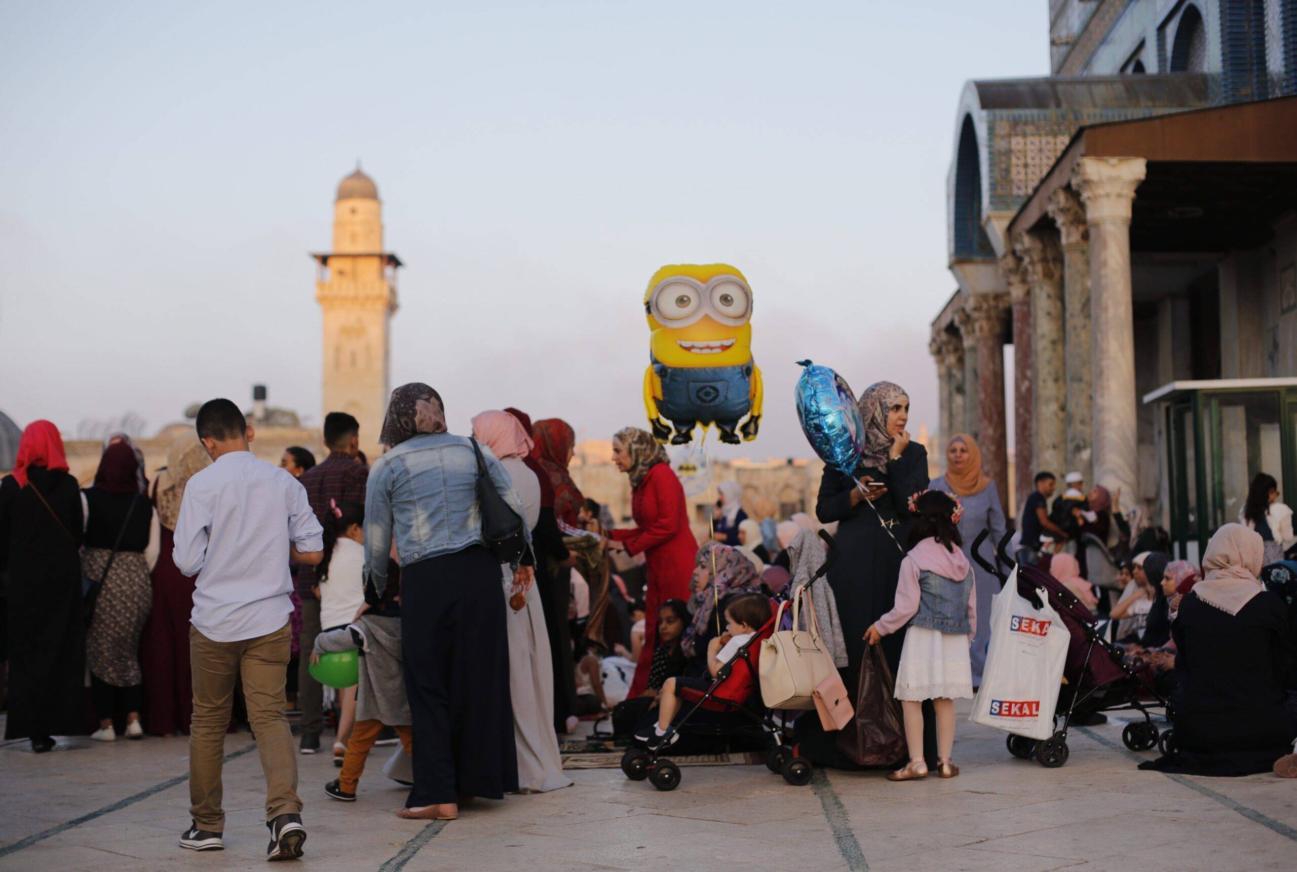 Families buying toys for their children after the Salat al Eid prayer at the Al-Aqsa mosque compound during the first day of the Eid Al Adha in Jerusalem on 21 August, 2018 [Mostafa Alkharouf/AnadoluAgency]