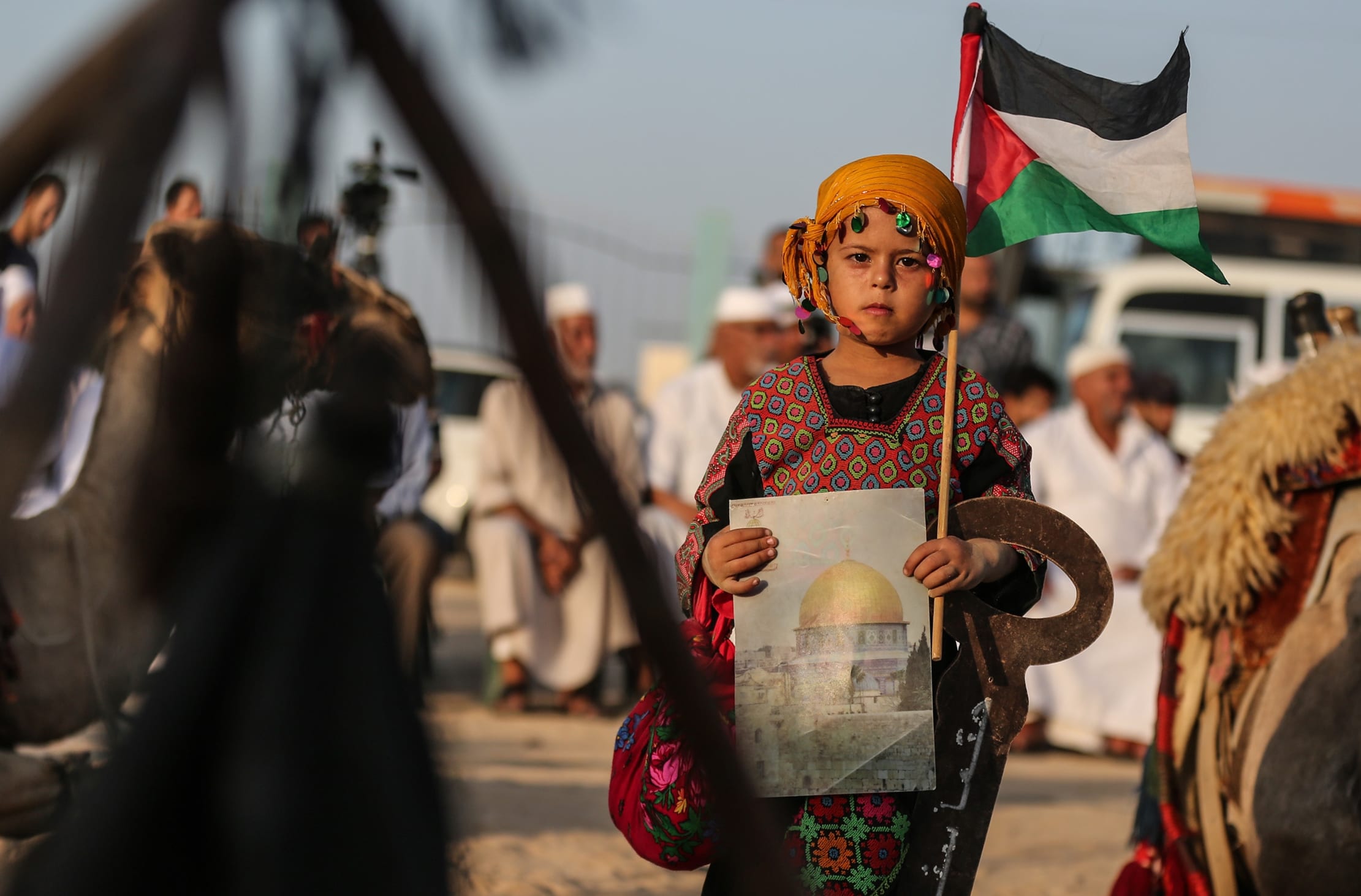 A girl holds a Palestinian flag in Gaza [Mustafa Hassona/Anadolu Agency]