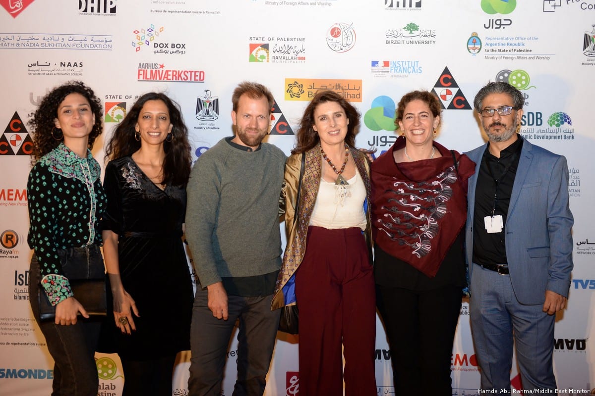 Participants at the launch of the annual Palestine Cinema Days festival at the Cultural Palace in the occupied West Bank city of Ramallah [Hamde Abu Rahma/Middle East Monitor]