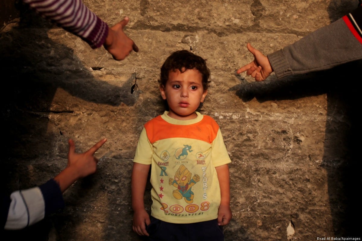 Palestinian children play outside their home in Rafah refugee camp in southern Gaza Strip, 9 November , 2013 [Eyad Al Baba/Apaimages]