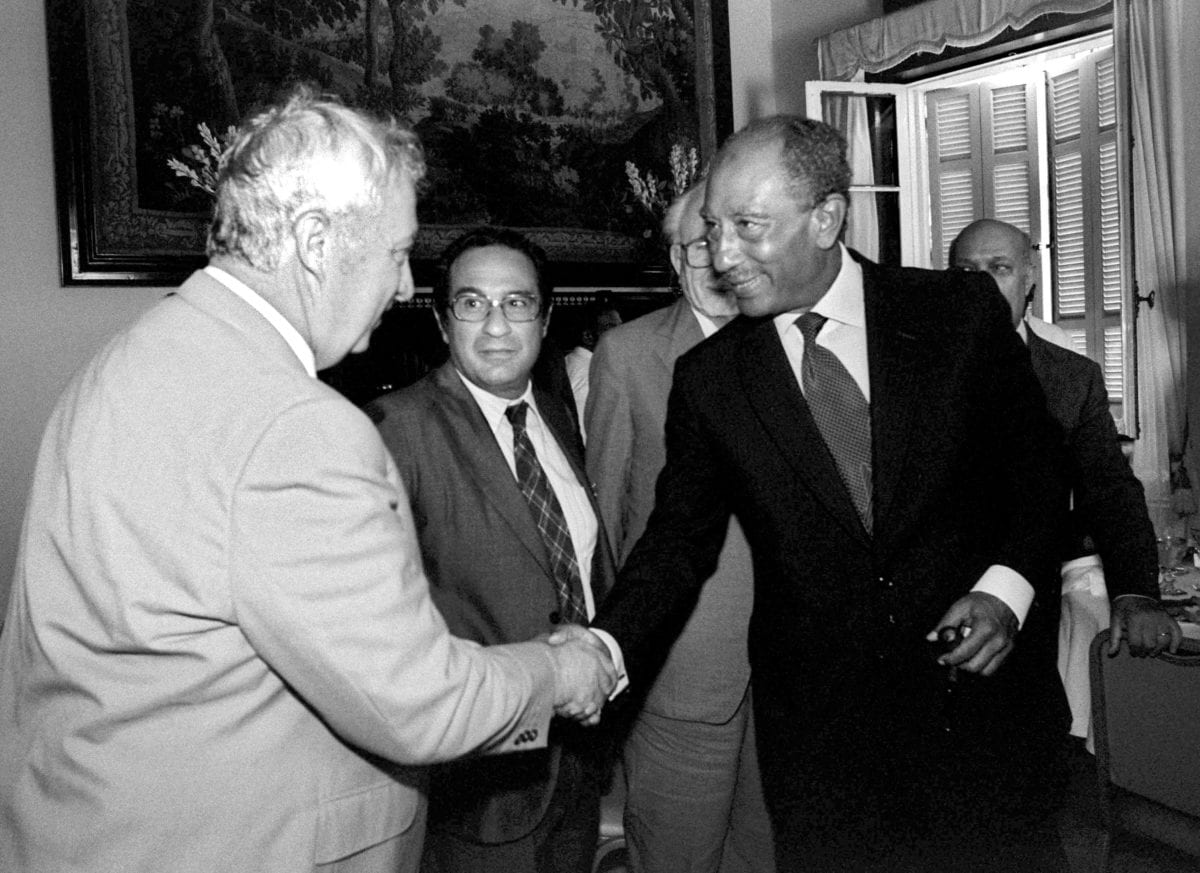 Then-Israeli Defense Minister Ariel Sharon (L) meets with Egyptian President Anwar Sadat August 25, 1981 in Alexandria, Egypt. [Chanania Herman/GPO/Getty Images]