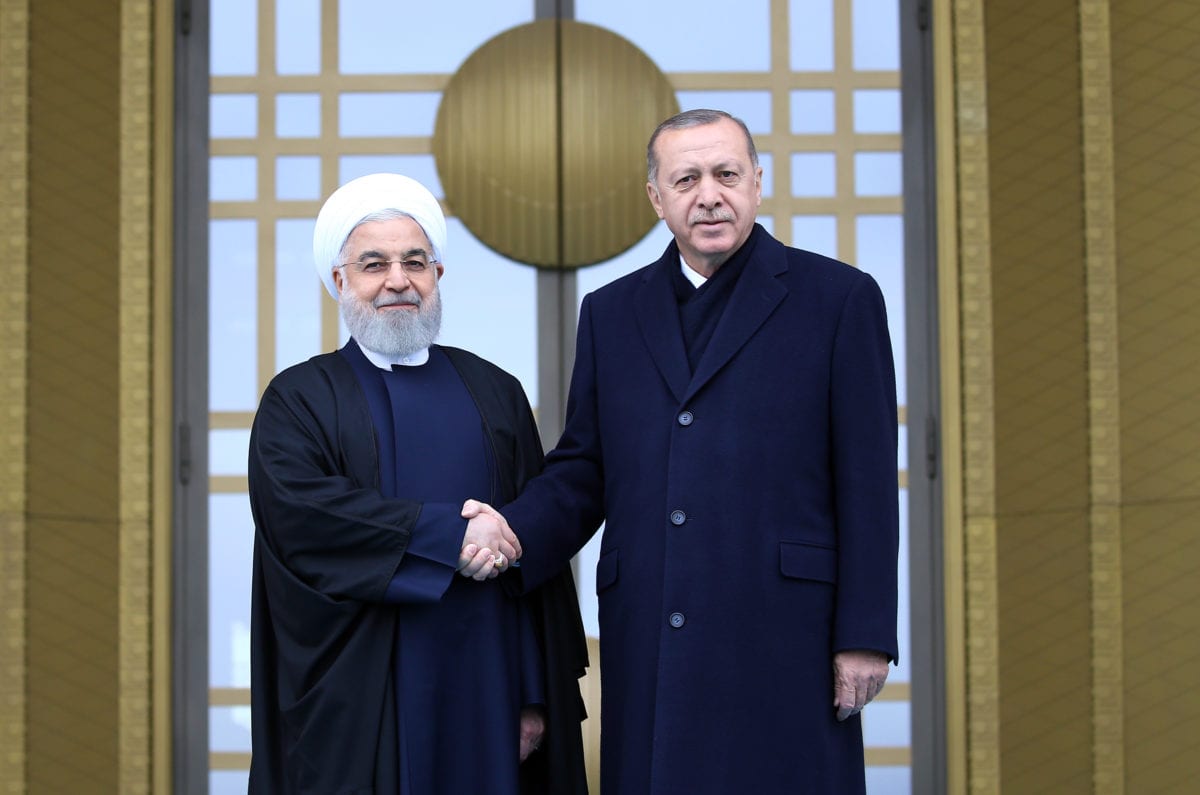 Turkish President Recep Tayyip Erdogan (R) and President of Iran, Hassan Rouhani (L) shake hands during an official welcoming ceremony at Presidential Complex in Ankara, Turkey on 20 December 2018. [Halil Sağırkaya - Anadolu Agency]