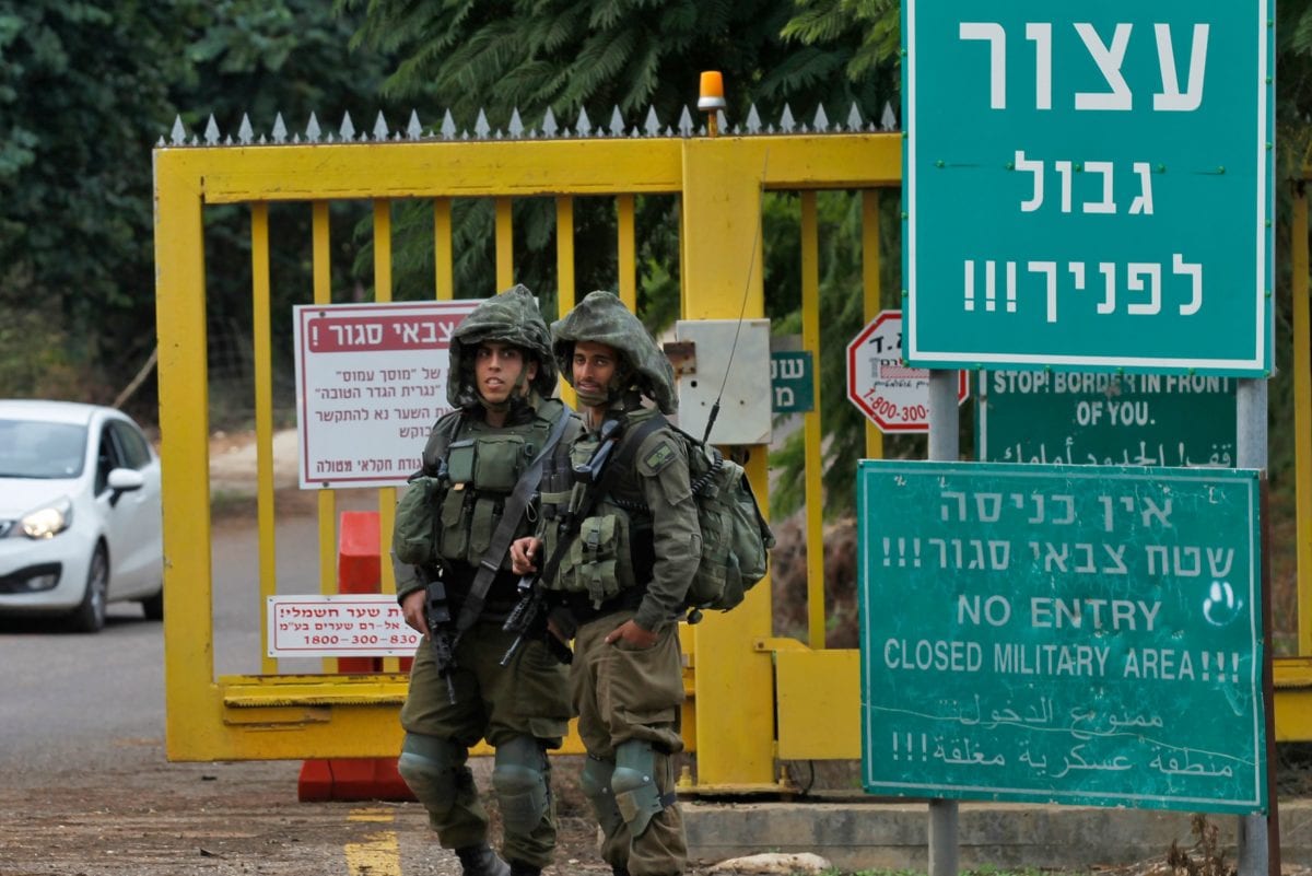 Israeli soldiers stand at a security checkpoint along a road near the northern Israeli town of Metula near the border with Lebanon on December 4, 2018 [JALAA MAREY/AFP/Getty Images]