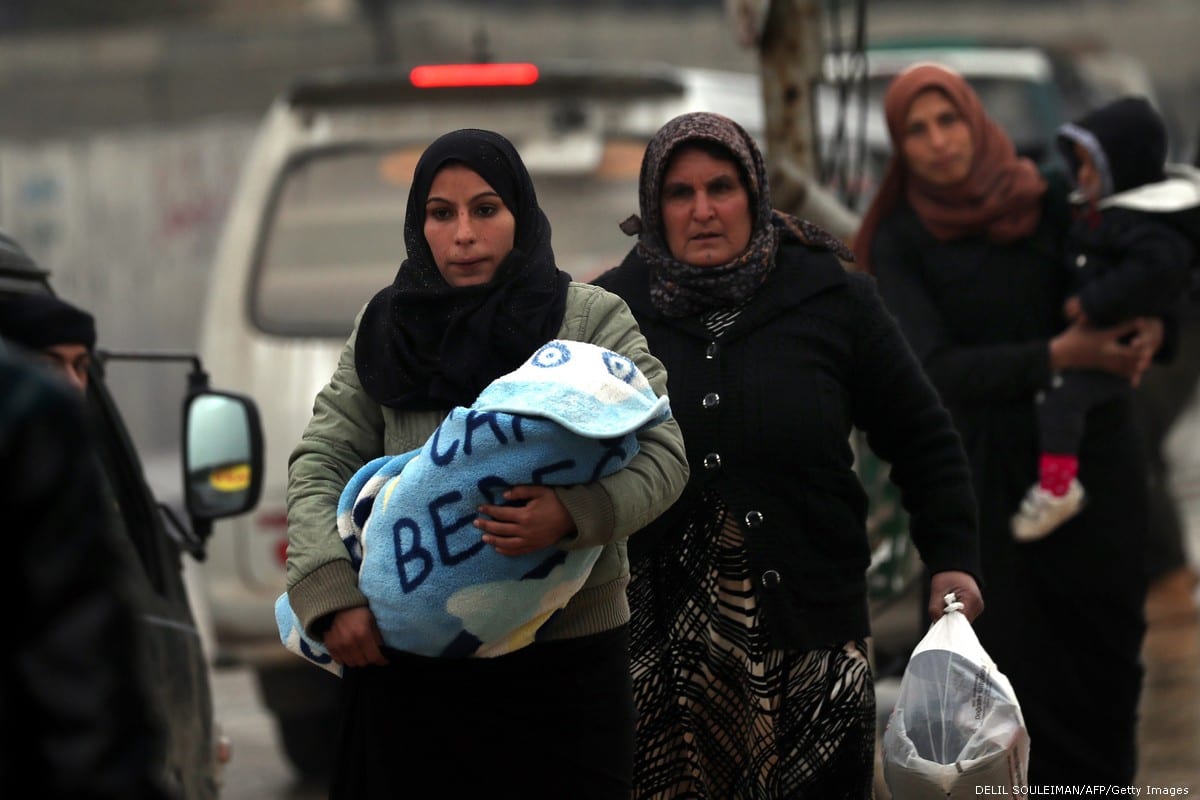 https://www.middleeastmonitor.com/wp-content/uploads/2019/01/2018_12-30-Syrians-women-carry-children-GettyImages-1075827552.jpg