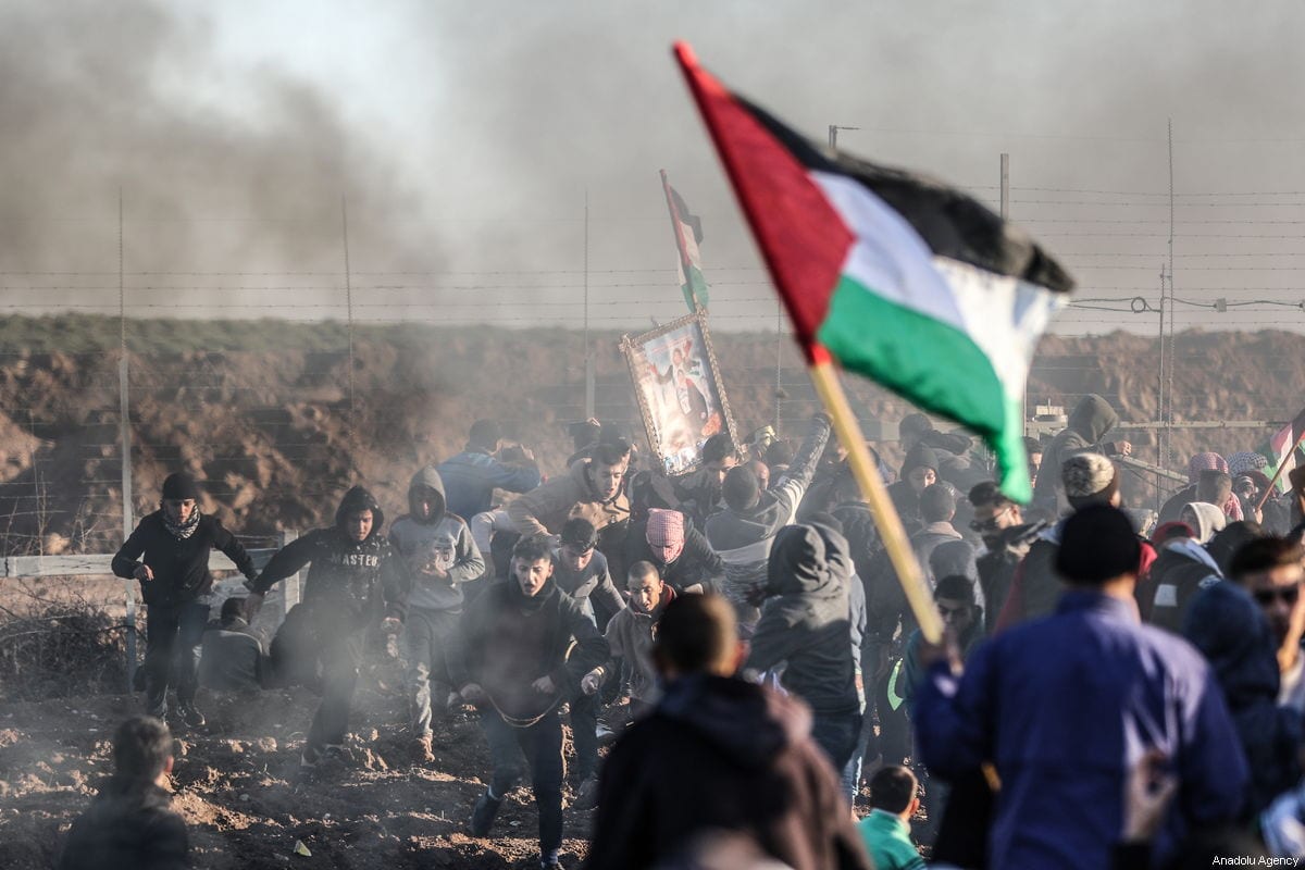 Israeli forces fire tear gas at Palestinians during the Great March of Return in Gaza on 11 January 2019 [Ali Jadallah/Anadolu Agency]