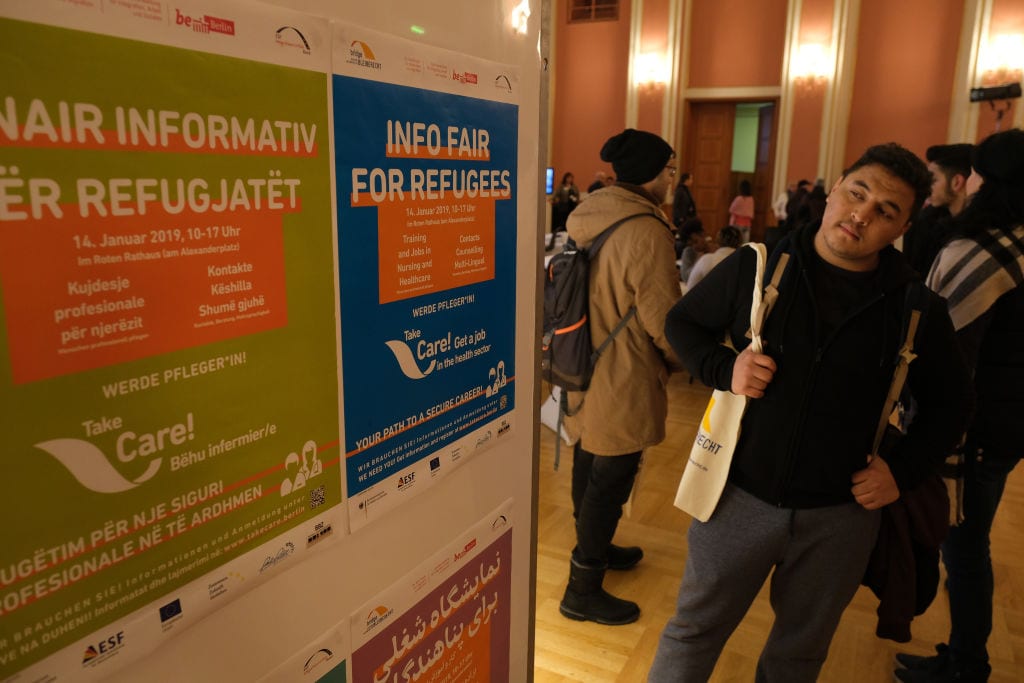 Visitors attend a jobs fair for refugees that promotes training programs and jobs in the caregiving and health care industries on January 14, 2019 in Berlin, Germany. [Sean Gallup/Getty Images]